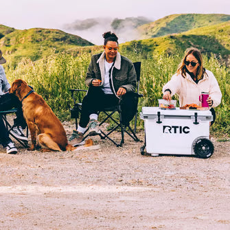 Friends camping with a cooler