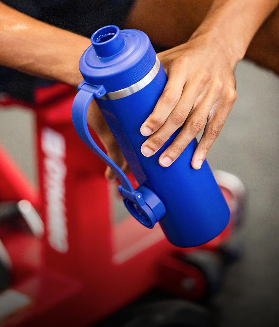 Person holding a blue bottle